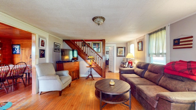 358 S Main St, Whiting, VT 05778 - living room featuring stairway, light wood-type flooring, and ornamental molding