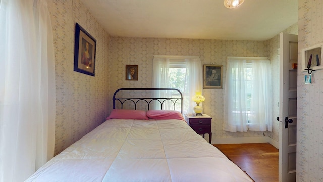 358 S Main St, Whiting, VT 05778 - bedroom with wallpapered walls, wood finished floors, and baseboards