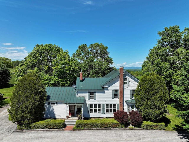 358 S Main St, Whiting, VT 05778 - view of front facade featuring a chimney, a standing seam roof, and metal roof
