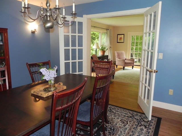 1782 Old Creamery Rd, Williston, VT 05495 - dining room with wood finished floors, a chandelier, french doors, and baseboards