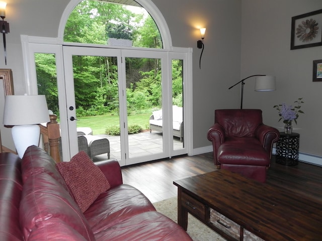 1782 Old Creamery Rd, Williston, VT 05495 - living room with wood finished floors, baseboards, french doors, and baseboard heating