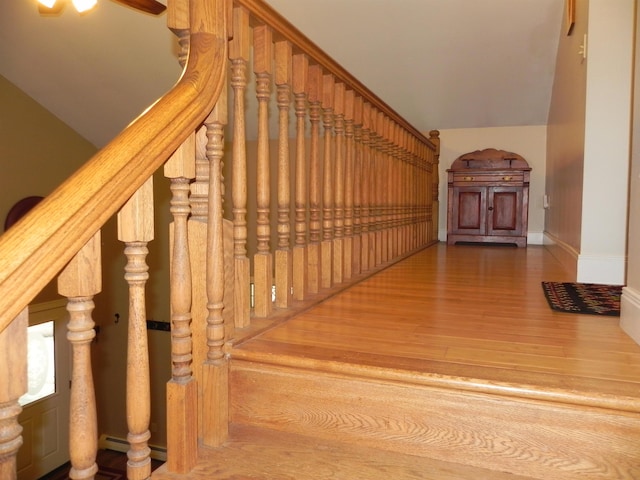 1782 Old Creamery Rd, Williston, VT 05495 - stairway featuring wood finished floors, baseboards, and vaulted ceiling