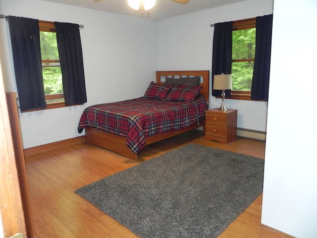 1782 Old Creamery Rd, Williston, VT 05495 - bedroom with a baseboard radiator, wood finished floors, multiple windows, and baseboards