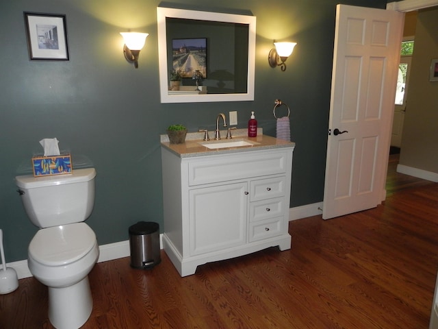 1782 Old Creamery Rd, Williston, VT 05495 - half bathroom with baseboards, toilet, vanity, and wood finished floors