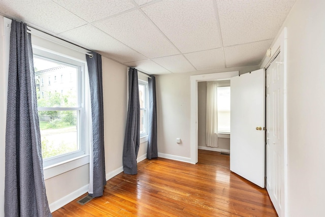 247 Prospect St, Manchester, NH 03104 - spare room featuring a paneled ceiling, light wood-style flooring, and baseboards
