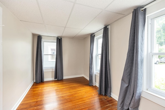 247 Prospect St, Manchester, NH 03104 - unfurnished room with light wood-type flooring, a paneled ceiling, and baseboards