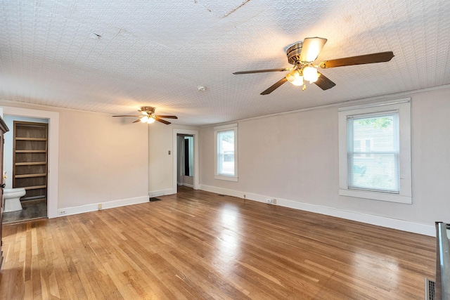 247 Prospect St, Manchester, NH 03104 - unfurnished living room with a ceiling fan, plenty of natural light, and light wood finished floors