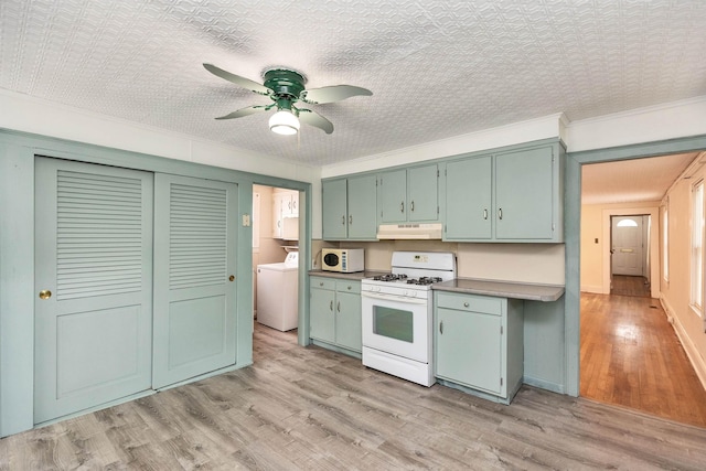 247 Prospect St, Manchester, NH 03104 - kitchen with white appliances, washer / clothes dryer, under cabinet range hood, a ceiling fan, and light wood-style floors