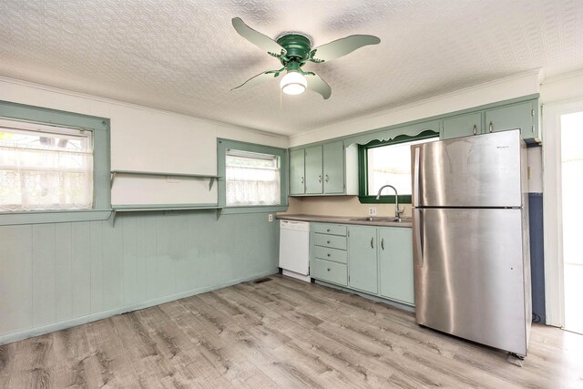247 Prospect St, Manchester, NH 03104 - kitchen featuring freestanding refrigerator, green cabinets, dishwasher, a sink, and light wood finished floors