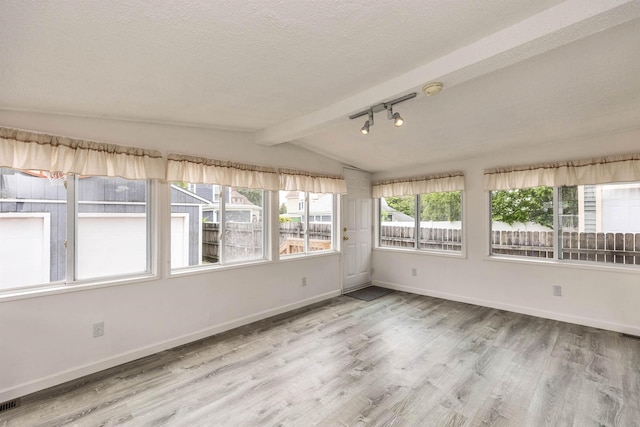 247 Prospect St, Manchester, NH 03104 - unfurnished sunroom featuring wood finished floors, baseboards, track lighting, and a textured ceiling