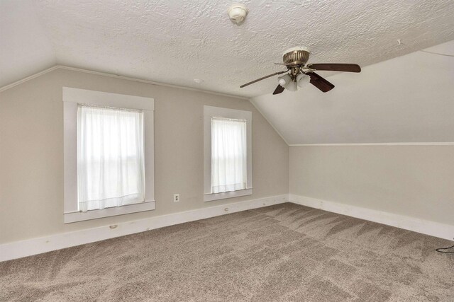 247 Prospect St, Manchester, NH 03104 - additional living space with vaulted ceiling, a ceiling fan, carpet flooring, baseboards, and a textured ceiling