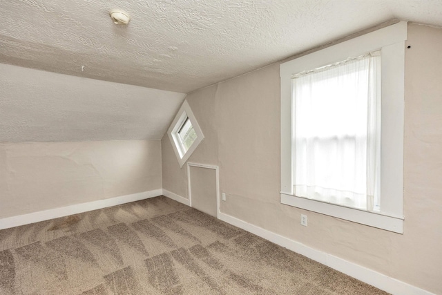 247 Prospect St, Manchester, NH 03104 - additional living space with a textured ceiling, carpet flooring, lofted ceiling, and baseboards