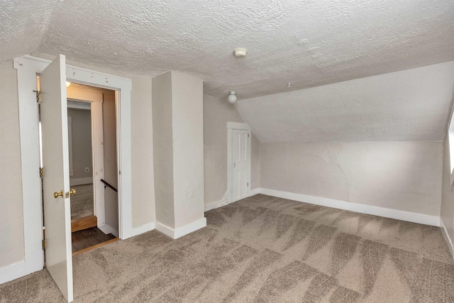 247 Prospect St, Manchester, NH 03104 - additional living space featuring carpet flooring, a textured ceiling, baseboards, and vaulted ceiling