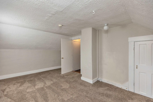 247 Prospect St, Manchester, NH 03104 - additional living space with carpet flooring, a textured ceiling, lofted ceiling, and baseboards