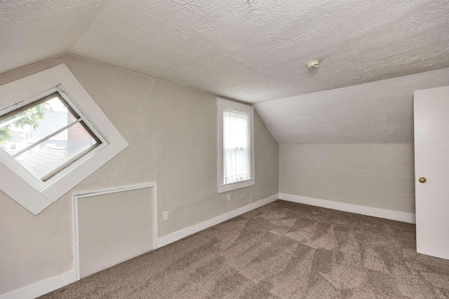 247 Prospect St, Manchester, NH 03104 - bonus room featuring lofted ceiling, carpet floors, a textured ceiling, and baseboards