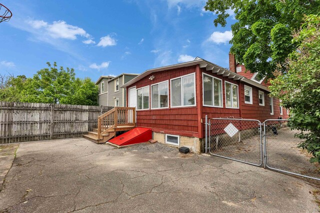 247 Prospect St, Manchester, NH 03104 - rear view of property with a fenced backyard, a chimney, and a gate