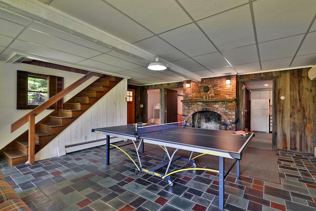 775 E Lake Rd, Ludlow, VT 05149 - game room featuring wood walls, a brick fireplace, a paneled ceiling, and a baseboard heating unit