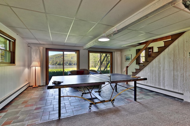 775 E Lake Rd, Ludlow, VT 05149 - rec room featuring a baseboard heating unit, wooden walls, a drop ceiling, healthy amount of natural light, and a water view
