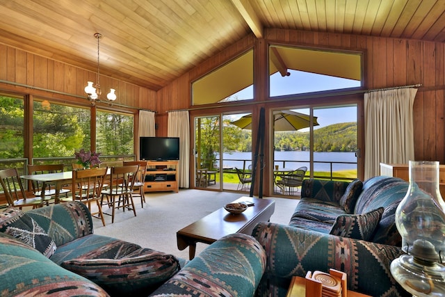 775 E Lake Rd, Ludlow, VT 05149 - carpeted living area with plenty of natural light, wood walls, a chandelier, vaulted ceiling, and wood ceiling