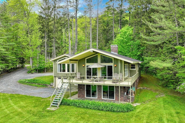 775 E Lake Rd, Ludlow, VT 05149 - rear view of property featuring a chimney, board and batten siding, a lawn, stairway, and driveway