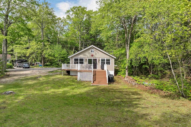 22 Shore Dr, Middleton, NH 03887 - view of front facade with a wooden deck, stairway, and a front lawn