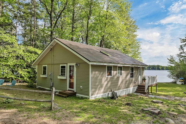 22 Shore Dr, Middleton, NH 03887 - view of front facade with a water view, metal roof, and a front yard