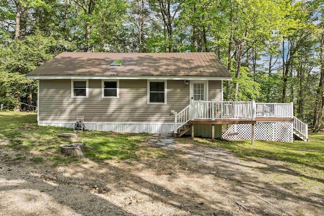 22 Shore Dr, Middleton, NH 03887 - rear view of house with stairs, a wooden deck, view of wooded area, and metal roof