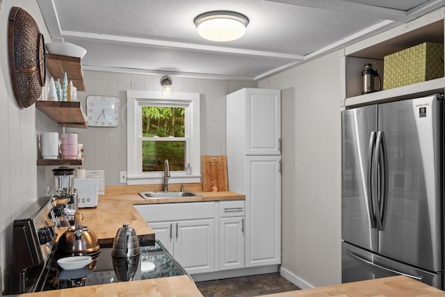 25 Hilltop Dr, Newbury, NH 03255 - kitchen with freestanding refrigerator, a sink, open shelves, wooden counters, and white cabinets