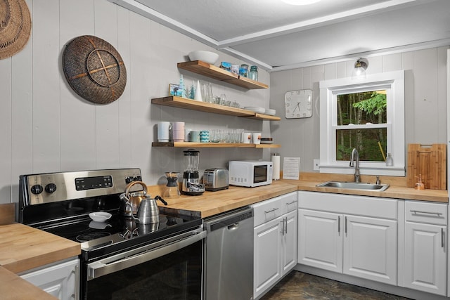 25 Hilltop Dr, Newbury, NH 03255 - kitchen with appliances with stainless steel finishes, wood counters, a sink, white cabinets, and wooden walls