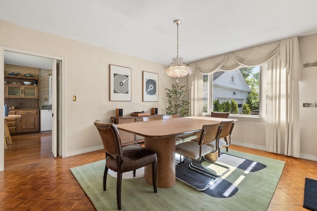 79 Silver St, Dover, NH 03820 - dining room featuring a chandelier and baseboards
