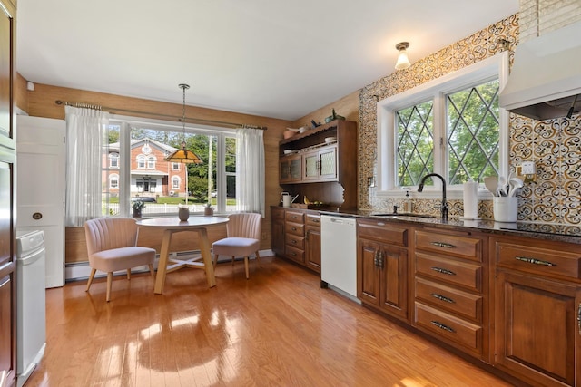 79 Silver St, Dover, NH 03820 - kitchen with dishwasher, a sink, extractor fan, light wood finished floors, and dark stone counters