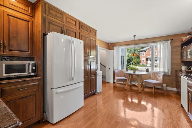 79 Silver St, Dover, NH 03820 - kitchen featuring white appliances, light wood-style flooring, pendant lighting, and brown cabinets