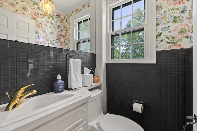 79 Silver St, Dover, NH 03820 - bathroom with wallpapered walls, toilet, a chandelier, vanity, and tile walls