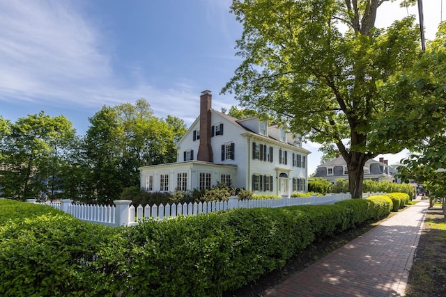 79 Silver St, Dover, NH 03820 - view of home's exterior featuring a chimney and a fenced front yard