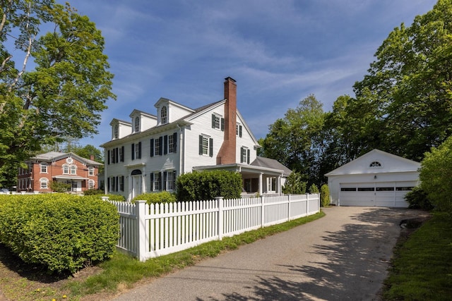 79 Silver St, Dover, NH 03820 - view of property exterior featuring a chimney, an outbuilding, and a garage