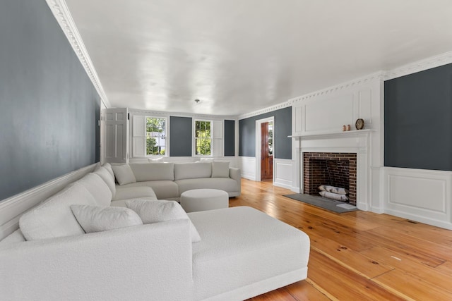 79 Silver St, Dover, NH 03820 - living area with a decorative wall, light wood-style flooring, a fireplace, and wainscoting