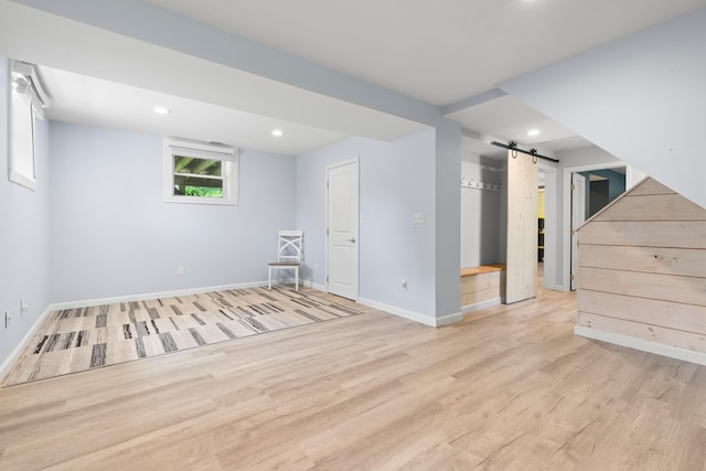 4 Crestview Ter, Stratham, NH 03885 - below grade area featuring a barn door, wood finished floors, baseboards, and recessed lighting