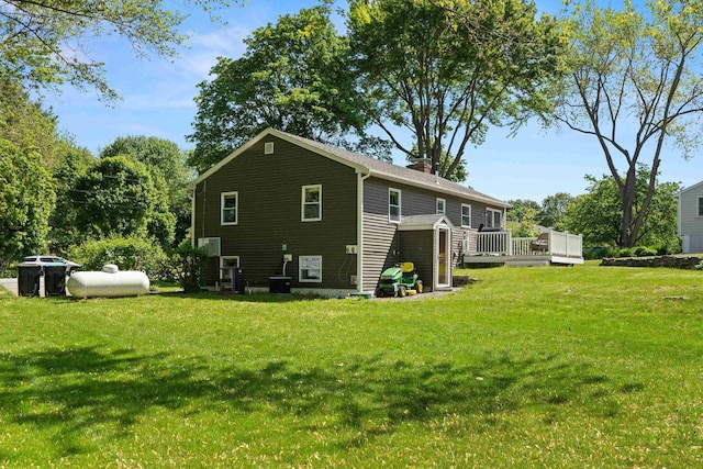 4 Crestview Ter, Stratham, NH 03885 - back of house featuring a wooden deck, a chimney, and a yard