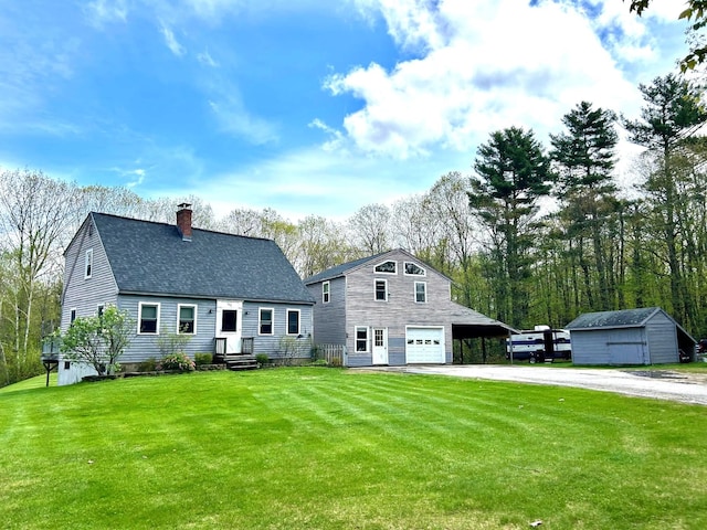 348 Ridge Rd, Northwood, NH 03261 - view of front facade with asphalt driveway, a chimney, an outbuilding, and a front yard