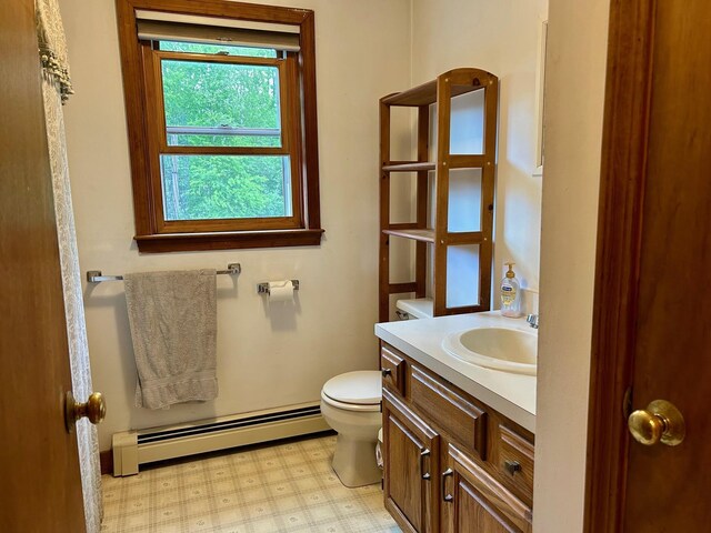 348 Ridge Rd, Northwood, NH 03261 - half bathroom featuring baseboard heating, toilet, vanity, and tile patterned floors
