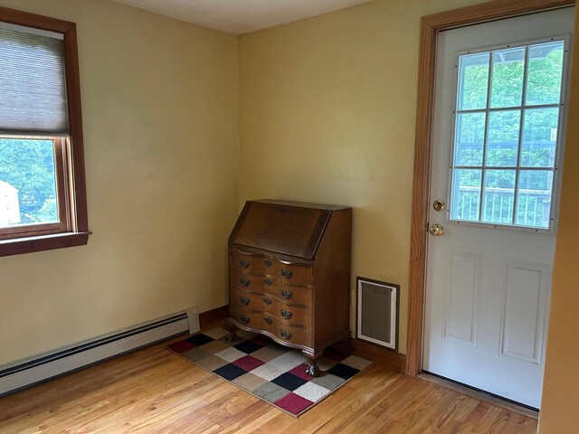348 Ridge Rd, Northwood, NH 03261 - doorway to outside featuring a baseboard heating unit and light wood-style floors