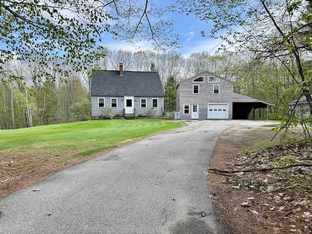 348 Ridge Rd, Northwood, NH 03261 - dutch colonial with a garage, asphalt driveway, an outbuilding, a chimney, and a front lawn