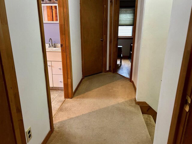 348 Ridge Rd, Northwood, NH 03261 - corridor with light colored carpet, a sink, and baseboards
