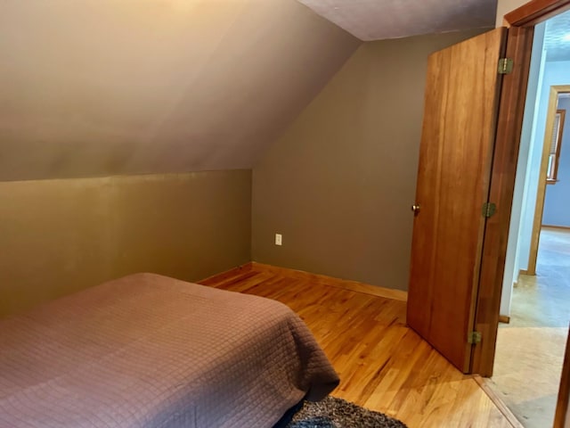 348 Ridge Rd, Northwood, NH 03261 - bedroom featuring wood finished floors, vaulted ceiling, and baseboards