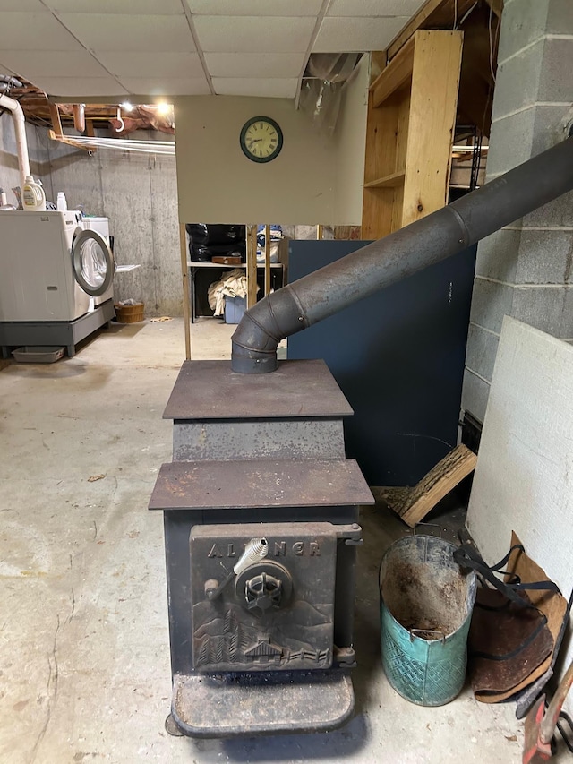 348 Ridge Rd, Northwood, NH 03261 - basement view of independent washer and dryer, concrete flooring, and a wood stove