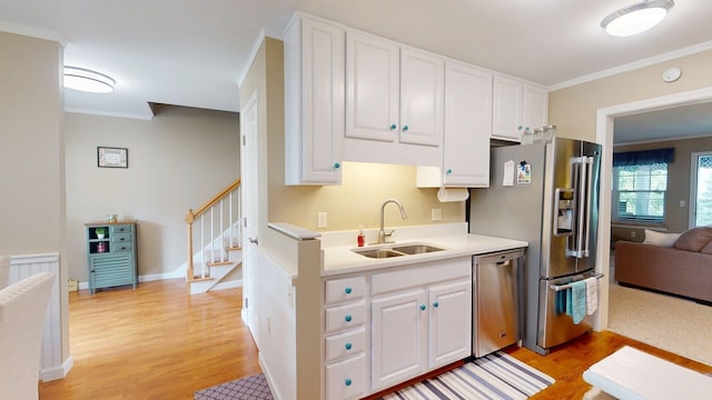 4 Bow Center Rd Unit B-3, Bow, NH 03304 - kitchen with appliances with stainless steel finishes, a sink, light wood-style flooring, crown molding, and light countertops