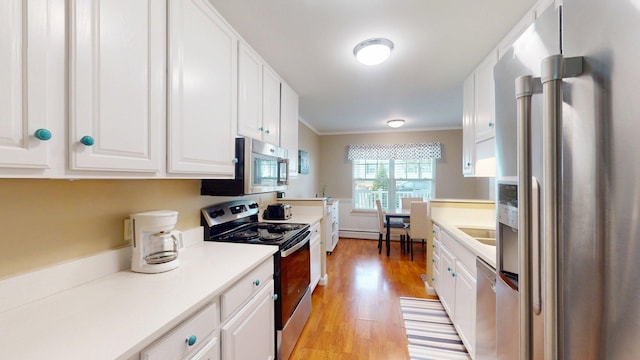 4 Bow Center Rd Unit B-3, Bow, NH 03304 - kitchen with appliances with stainless steel finishes, white cabinetry, light wood-type flooring, crown molding, and light countertops