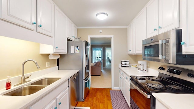 4 Bow Center Rd Unit B-3, Bow, NH 03304 - kitchen featuring appliances with stainless steel finishes, a sink, white cabinetry, light countertops, and light wood-type flooring