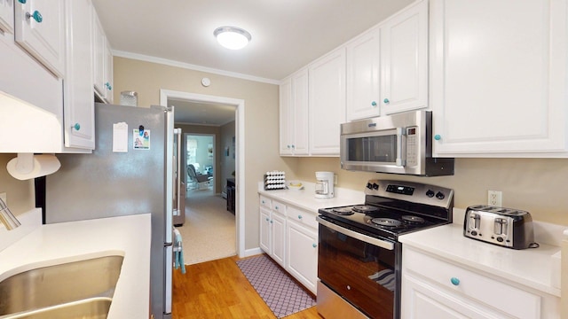 4 Bow Center Rd Unit B-3, Bow, NH 03304 - kitchen featuring appliances with stainless steel finishes, white cabinetry, light wood-type flooring, a sink, and light countertops