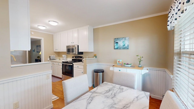 4 Bow Center Rd Unit B-3, Bow, NH 03304 - kitchen with stainless steel appliances, wainscoting, white cabinetry, light countertops, and ornamental molding